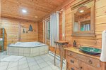 Master bathroom has a separate walk-in shower and jetted soaking tub